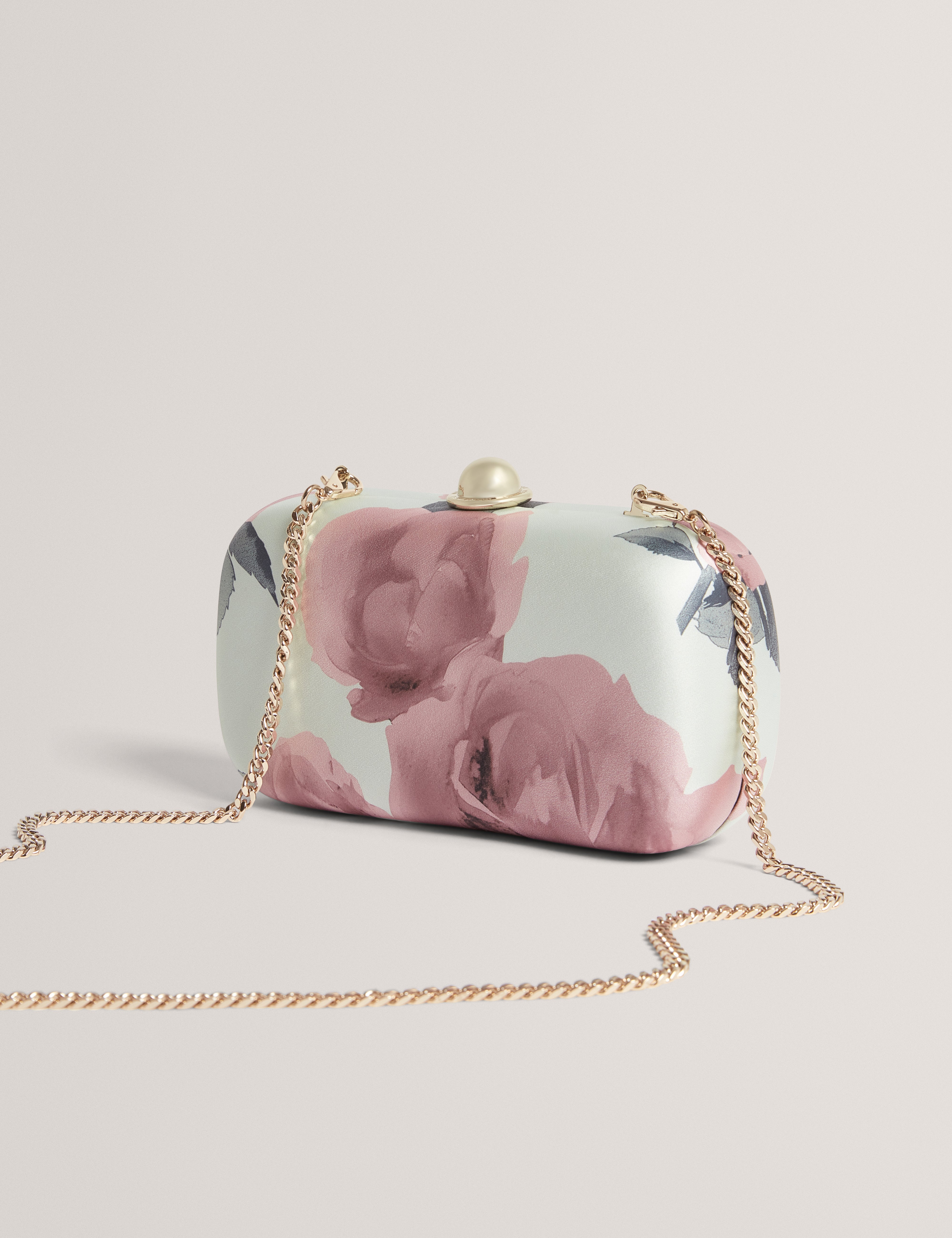 حقيبة كلاتش ليزيلا الصلبة المطبوعة بالورود باللون الأخضر الفاتح